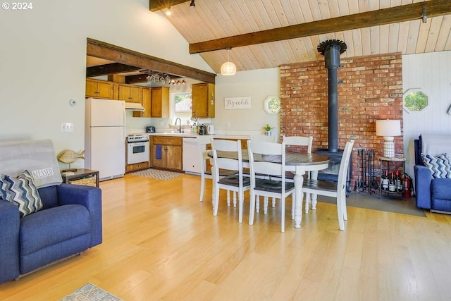 dining area with sink, lofted ceiling with beams, light hardwood / wood-style floors, and wood ceiling