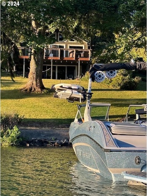 view of property's community featuring a yard and a water view