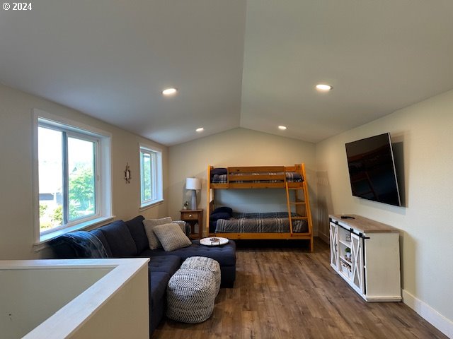 bedroom featuring vaulted ceiling and dark wood-type flooring