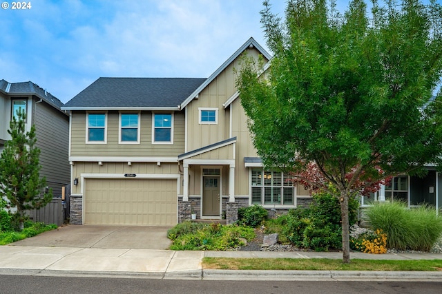 craftsman-style house with a garage, stone siding, board and batten siding, and concrete driveway