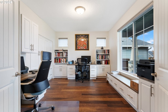 office area featuring a textured ceiling and dark wood-type flooring