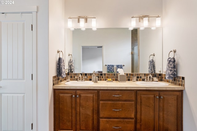 bathroom featuring vanity and decorative backsplash