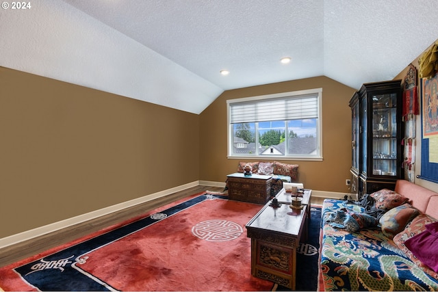 office featuring hardwood / wood-style flooring, a textured ceiling, and lofted ceiling