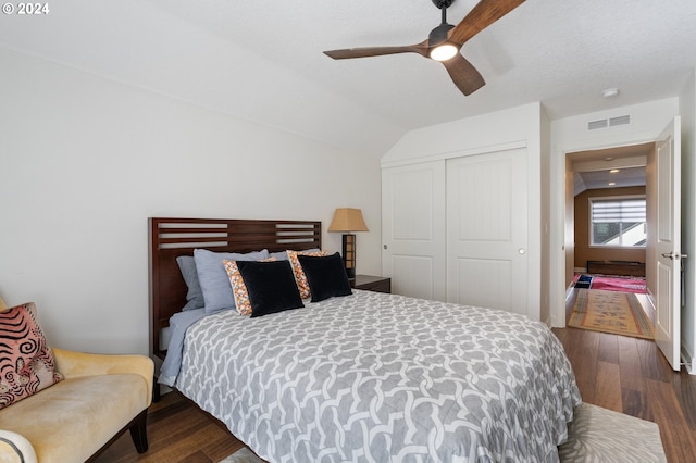 bedroom with a closet, ceiling fan, lofted ceiling, and dark hardwood / wood-style flooring