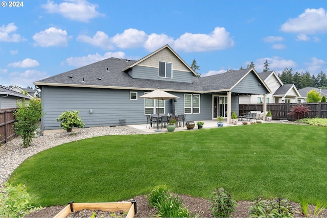 back of property with a patio and a yard