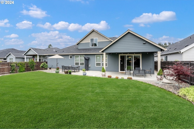 rear view of property with a patio and a yard