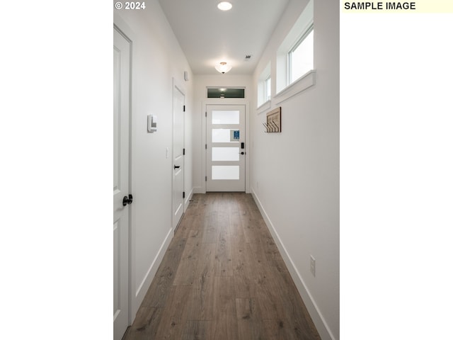 hall with hardwood / wood-style flooring