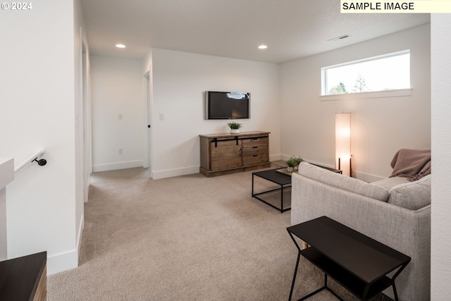 living area featuring recessed lighting, light carpet, and baseboards