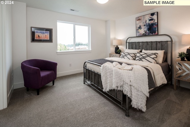 bedroom with carpet floors, visible vents, and baseboards