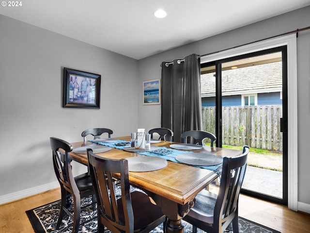 dining space with light hardwood / wood-style flooring