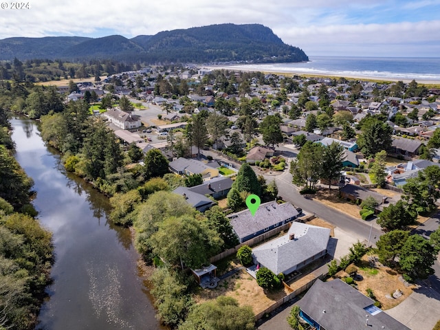 aerial view featuring a water and mountain view