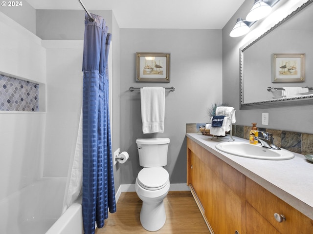 full bathroom with shower / bath combo with shower curtain, toilet, wood-type flooring, and vanity