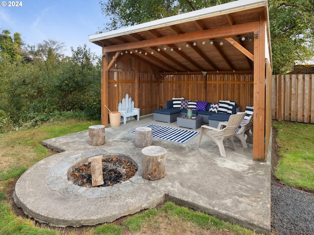 view of patio featuring an outdoor living space with a fire pit