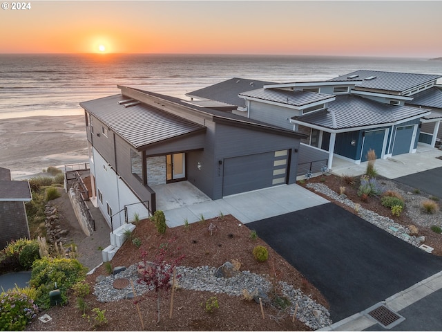 view of front of property featuring a water view and a garage