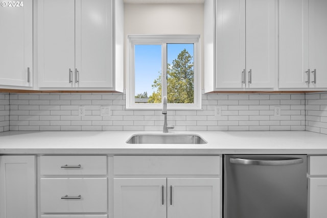 kitchen with sink, dishwasher, white cabinets, and backsplash