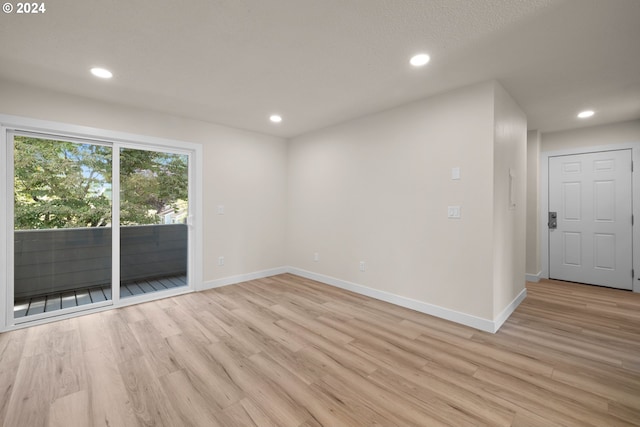 unfurnished room with light wood-type flooring