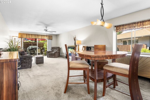 dining room with carpet, ceiling fan, and baseboard heating