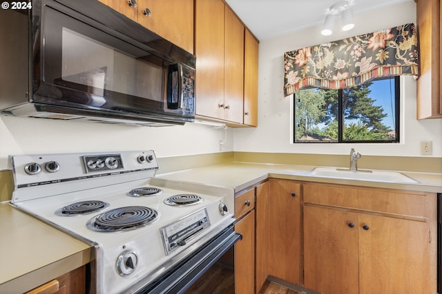 kitchen with white range with electric stovetop and sink