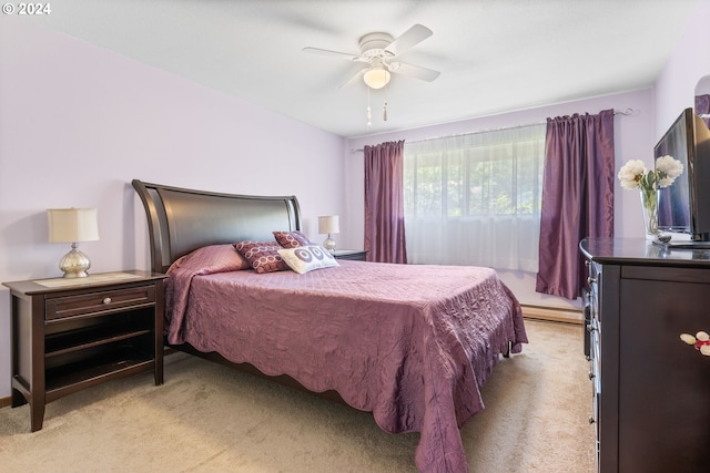 bedroom featuring light carpet, baseboard heating, and ceiling fan