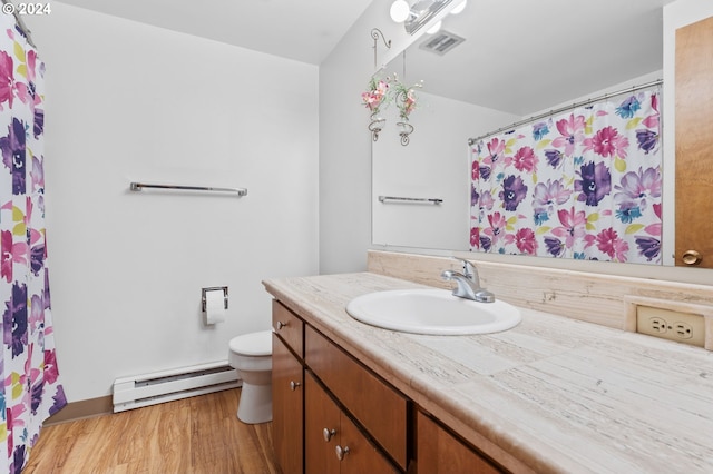 bathroom featuring toilet, vanity, a baseboard radiator, and wood-type flooring