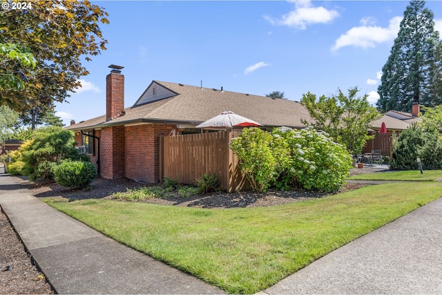 view of side of property with a yard