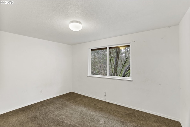 carpeted empty room with a textured ceiling