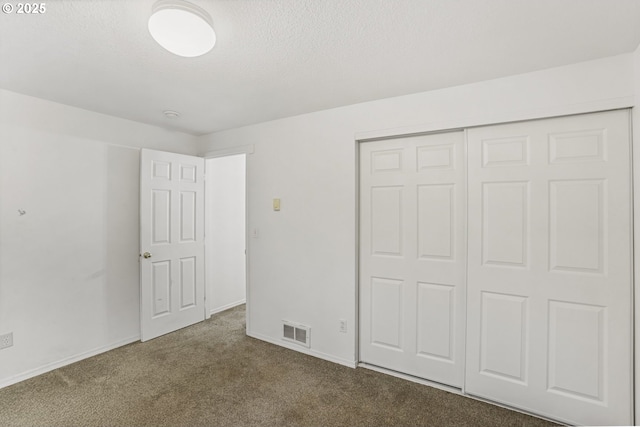 unfurnished bedroom featuring carpet and a closet