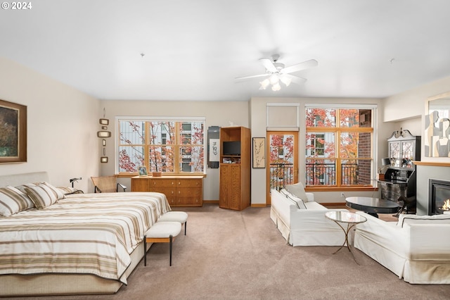 carpeted bedroom with ceiling fan and multiple windows