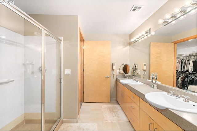 bathroom featuring vanity, tile patterned flooring, and an enclosed shower