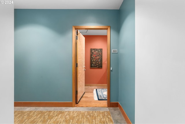 corridor with light hardwood / wood-style flooring