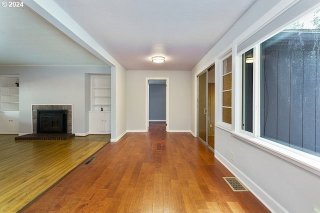 hall with hardwood / wood-style floors and built in features