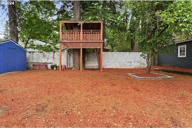 view of yard with a storage shed and a wooden deck