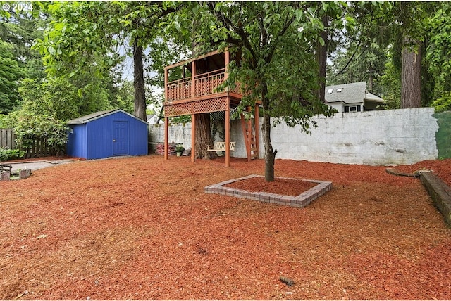 view of yard with a shed and a wooden deck