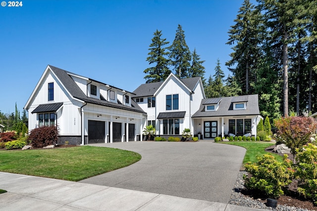 modern inspired farmhouse featuring a garage, french doors, and a front lawn