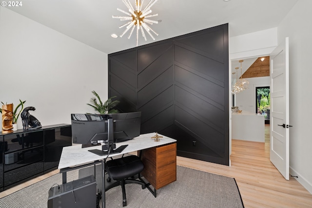 office space with light hardwood / wood-style flooring and an inviting chandelier