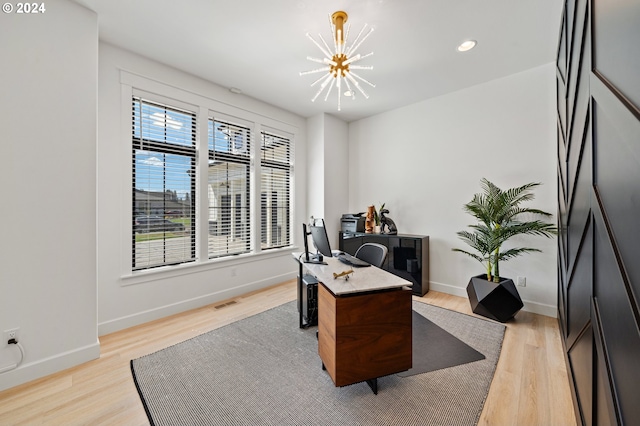 office area with a notable chandelier and light wood-type flooring