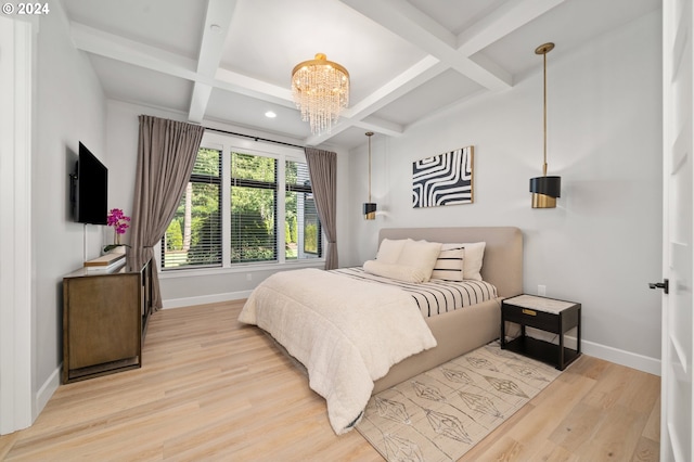 bedroom featuring coffered ceiling, a notable chandelier, beamed ceiling, and light hardwood / wood-style flooring