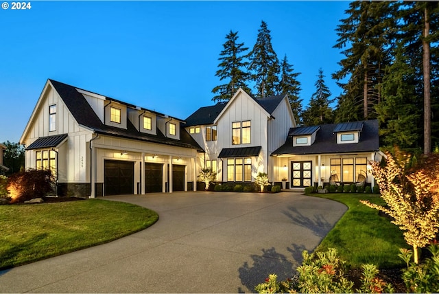 modern farmhouse style home featuring a garage and a front lawn