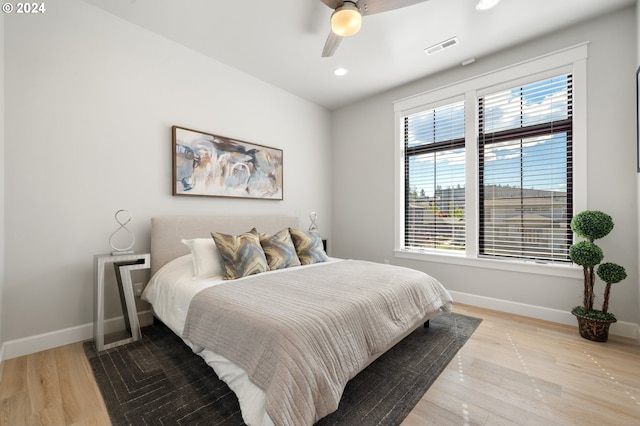 bedroom with ceiling fan and light hardwood / wood-style flooring