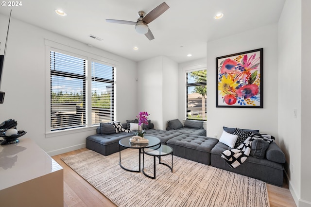 living room with ceiling fan and light hardwood / wood-style floors