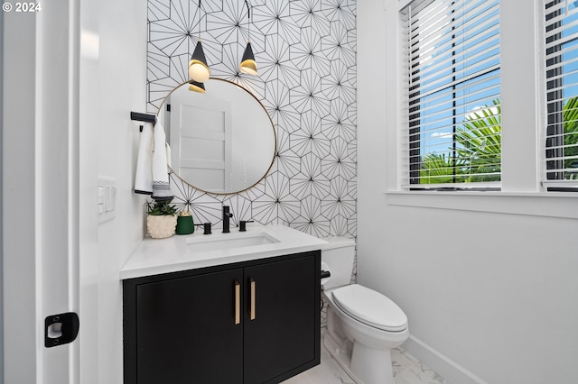 bathroom featuring vanity and toilet