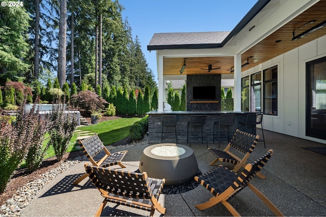 view of patio featuring ceiling fan and a bar