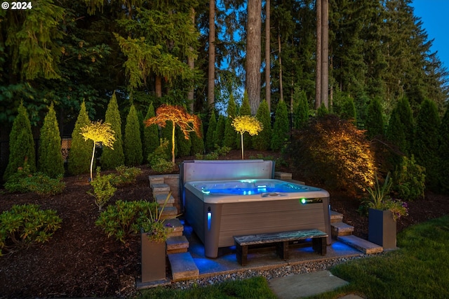 view of swimming pool with a hot tub