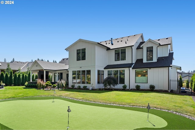 rear view of property with a yard