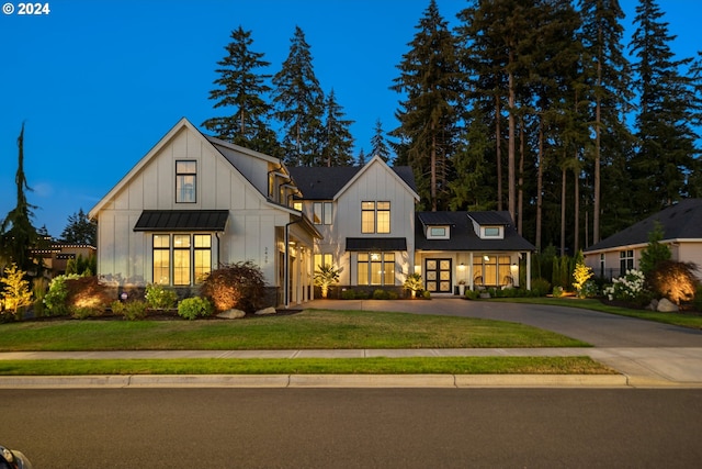 modern inspired farmhouse with a yard