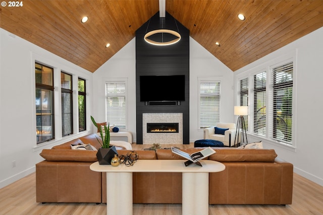 living room with a fireplace, light hardwood / wood-style floors, a wealth of natural light, and wood ceiling