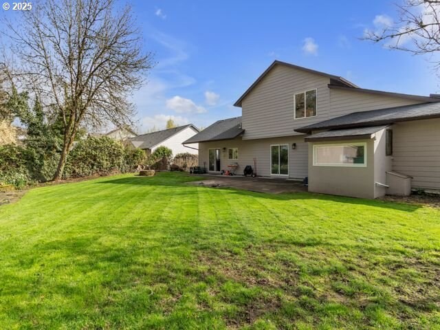 724 Kayla Way, Monmouth, OR 97361 - back of house with a lawn and a patio area