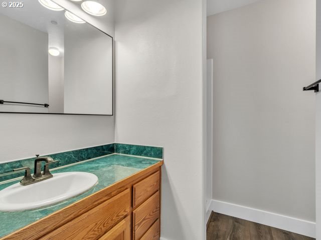 724 Kayla Way, Monmouth, OR 97361 - bathroom featuring baseboards, wood finished floors, and vanity