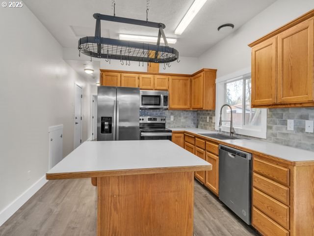 724 Kayla Way, Monmouth, OR 97361 - kitchen featuring a sink, light wood-type flooring, light countertops, and appliances with stainless steel finishes