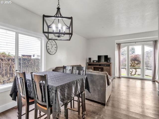 724 Kayla Way, Monmouth, OR 97361 - dining room with an inviting chandelier, baseboards, and wood finished floors